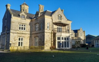 Image of a 3d laser scanning survey taking place at Bay House School in Gosport. In the image there is a tripod mounted Laser scanner and control spheres.