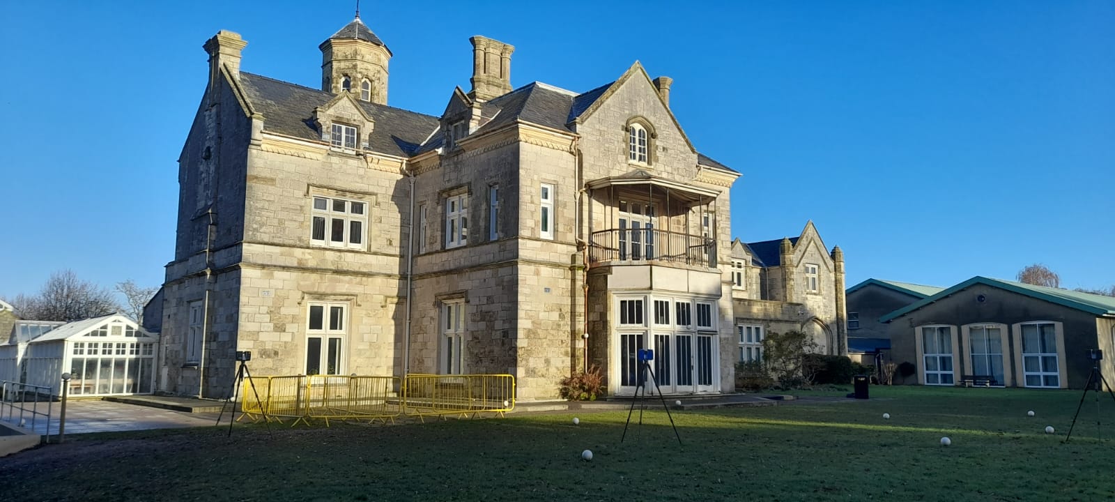 Image of a 3d laser scanning survey taking place at Bay House School in Gosport. In the image there is a tripod mounted Laser scanner and control spheres.